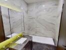 Modern bathroom with marble walls and LED lighting