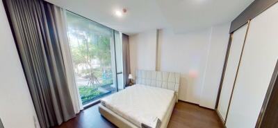 Modern bedroom with large window and natural light