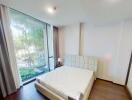 Modern bedroom with large window and natural light