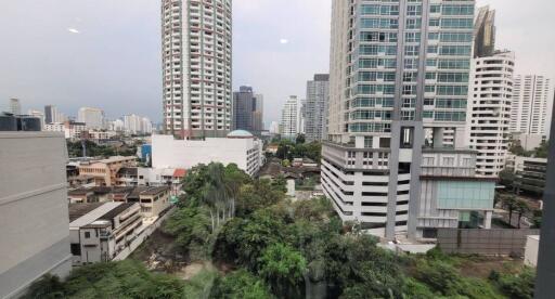 Urban skyline and green spaces seen from a high-rise building window