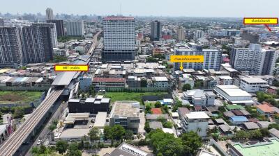 Aerial view of a cityscape with buildings, roads, and greenery