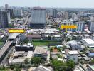 Aerial view of a cityscape with buildings, roads, and greenery