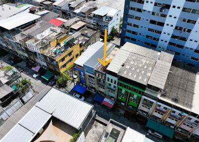 Aerial view of a row of colorful buildings with varying roof types