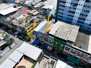 Aerial view of a row of colorful buildings with varying roof types