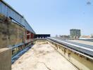 Rooftop area of a building with some structures and city view in the distance