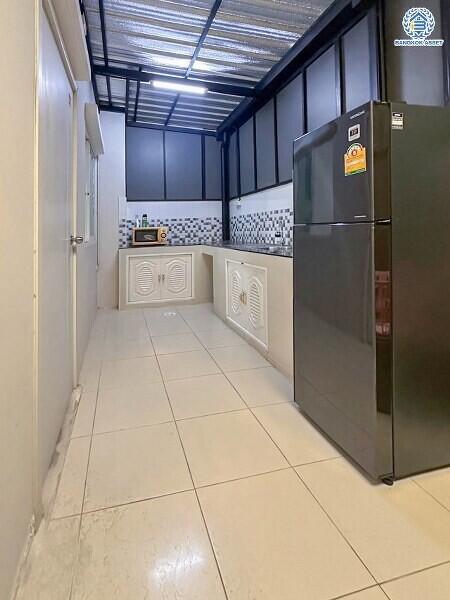 Compact kitchen area with modern appliances and tiled flooring