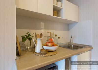 Modern kitchen with stainless steel sink and white cabinetry