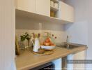 Modern kitchen with stainless steel sink and white cabinetry