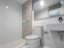 Modern bathroom with white ceramic fittings and grey tiles