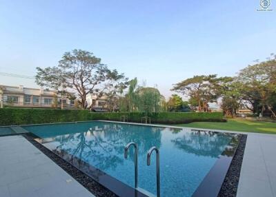 Spacious outdoor area with swimming pool and landscaped garden