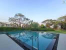 Spacious outdoor area with swimming pool and landscaped garden