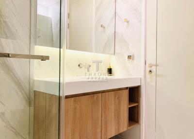 Modern bathroom interior with marble walls and wooden vanity