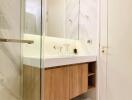 Modern bathroom interior with marble walls and wooden vanity