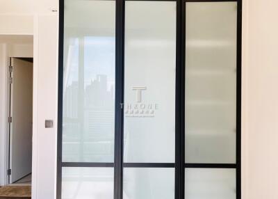 Modern building foyer with frosted glass doors and city view