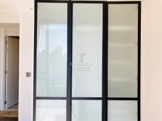 Modern building foyer with frosted glass doors and city view