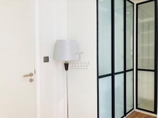 Modern entrance hall with white walls and glass door