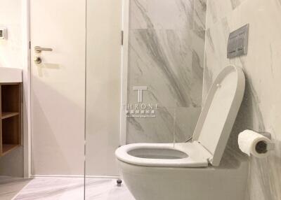 Modern bathroom interior with a focus on the toilet and marble walls