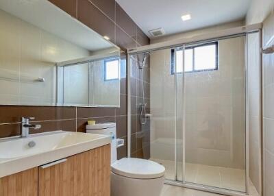 Modern bathroom with glass shower cubicle and wooden vanity