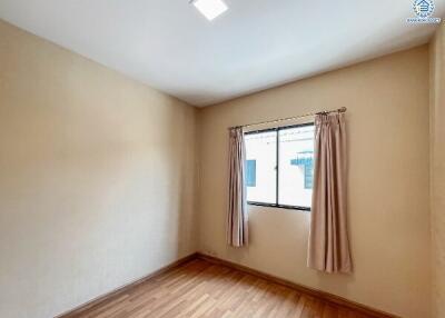 Bright and clean bedroom with a window and hardwood floors