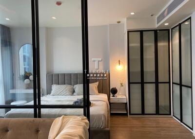 Modern bedroom with large bed and stylish glass partition