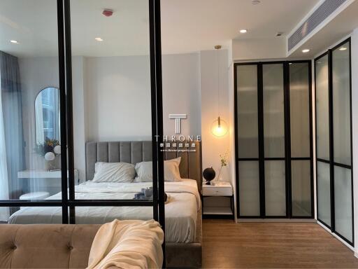 Modern bedroom with large bed and stylish glass partition