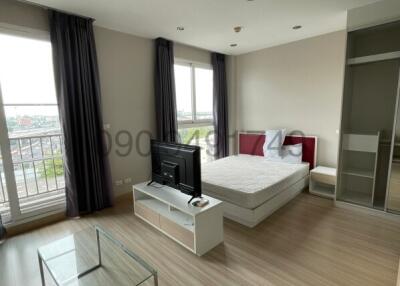 Spacious furnished bedroom with ample natural light and modern amenities