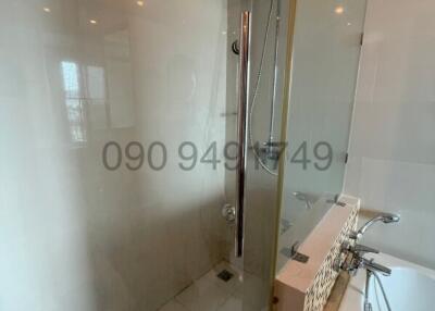 Modern bathroom interior with glass shower and tiled walls