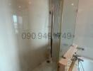 Modern bathroom interior with glass shower and tiled walls