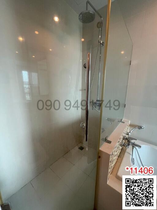 Modern bathroom interior with glass shower and tiled walls