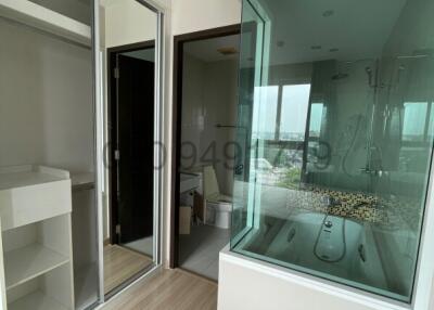 Modern bedroom interior with open ensuite bathroom featuring a jacuzzi