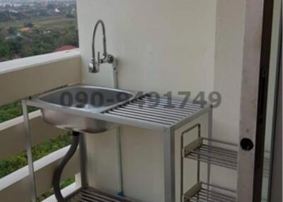 Balcony with sink and shelving unit overlooking a scenic view