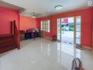 Spacious bedroom with bright red walls and glossy white tiled flooring