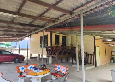 Covered patio area with outdoor furniture and carport