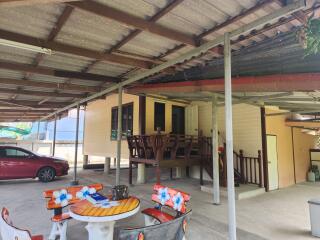 Covered patio area with outdoor furniture and carport