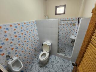 Tiled bathroom with toilet and bidet