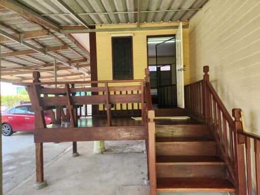 Entrance to the building with wooden stairs and deck