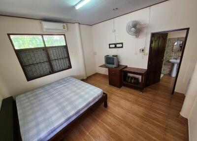 Spacious bedroom with air conditioning and attached bathroom