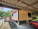 Exterior view of a raised house with underneath car parking