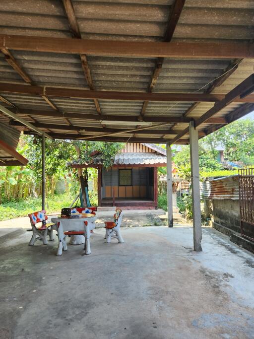 Cozy outdoor patio area with seating and a view of a traditional house