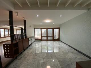 Spacious living room with marble flooring and large windows