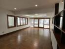 Spacious living room with hardwood flooring and natural light