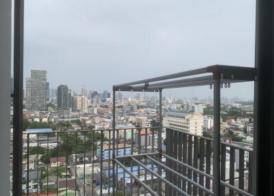 City view from high-rise apartment balcony with safety railing
