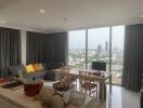 Spacious living room with large windows, dining table, and city view