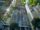 Exterior view of Hampton Residence skyscraper with lush greenery