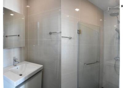 Modern bathroom with glass shower and sleek sink in Hampton Residence