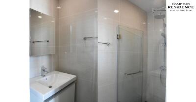 Modern bathroom with glass shower and sleek sink in Hampton Residence