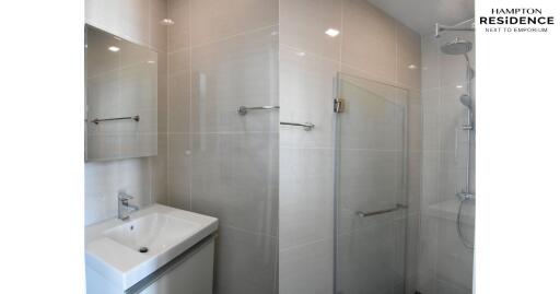 Modern bathroom with glass shower and sleek sink in Hampton Residence