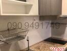 Modern kitchen with stainless steel sink and wooden cabinets