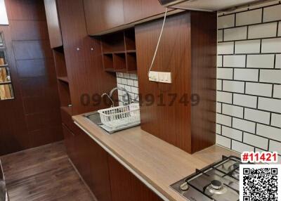 Modern kitchen with wooden cabinets and gas stove