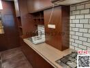 Modern kitchen with wooden cabinets and gas stove